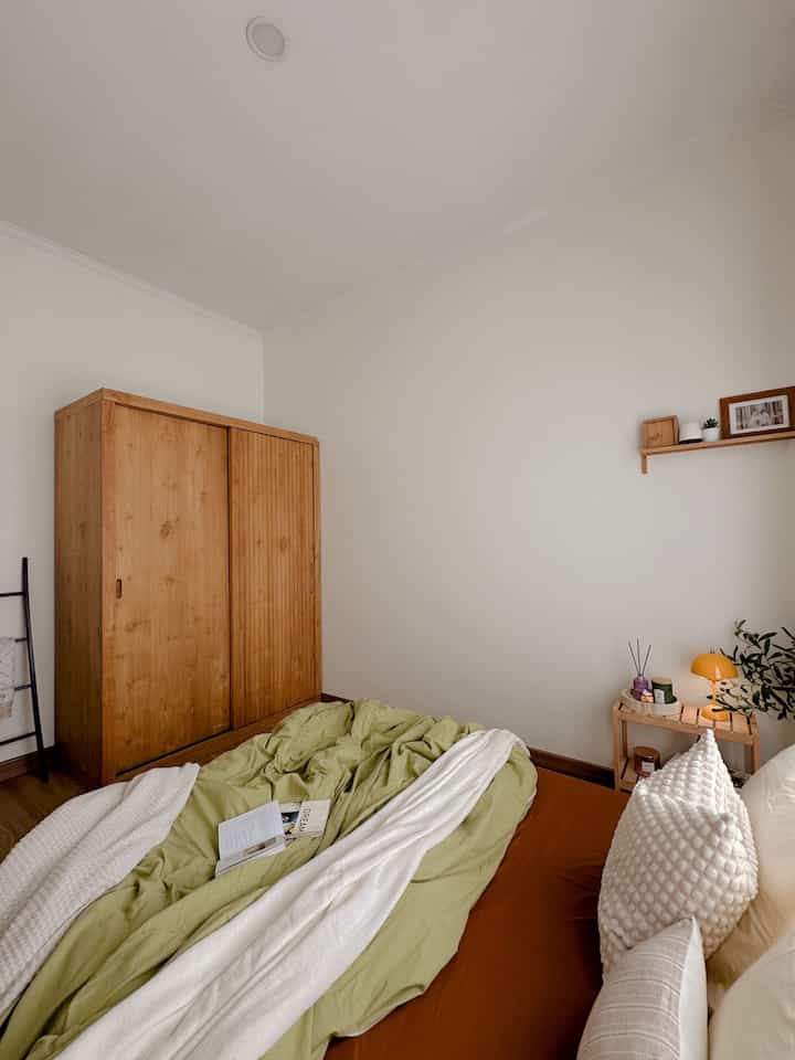 Natural color and wood tone 4.5 tatami bedroom featuring simple bed and wardrobe with a cozy atmosphere