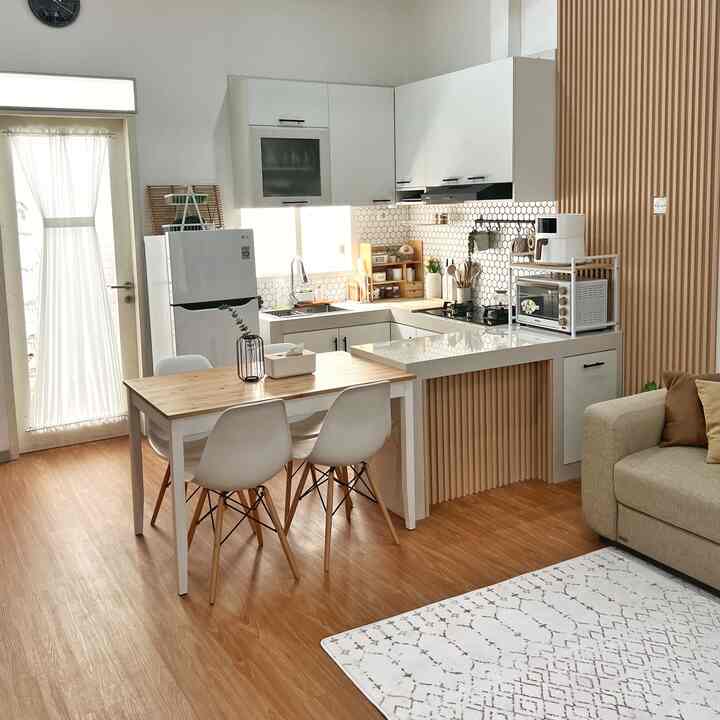 White and wood tone compact open plan kitchen and dining area featuring simple furniture with a cozy atmosphere