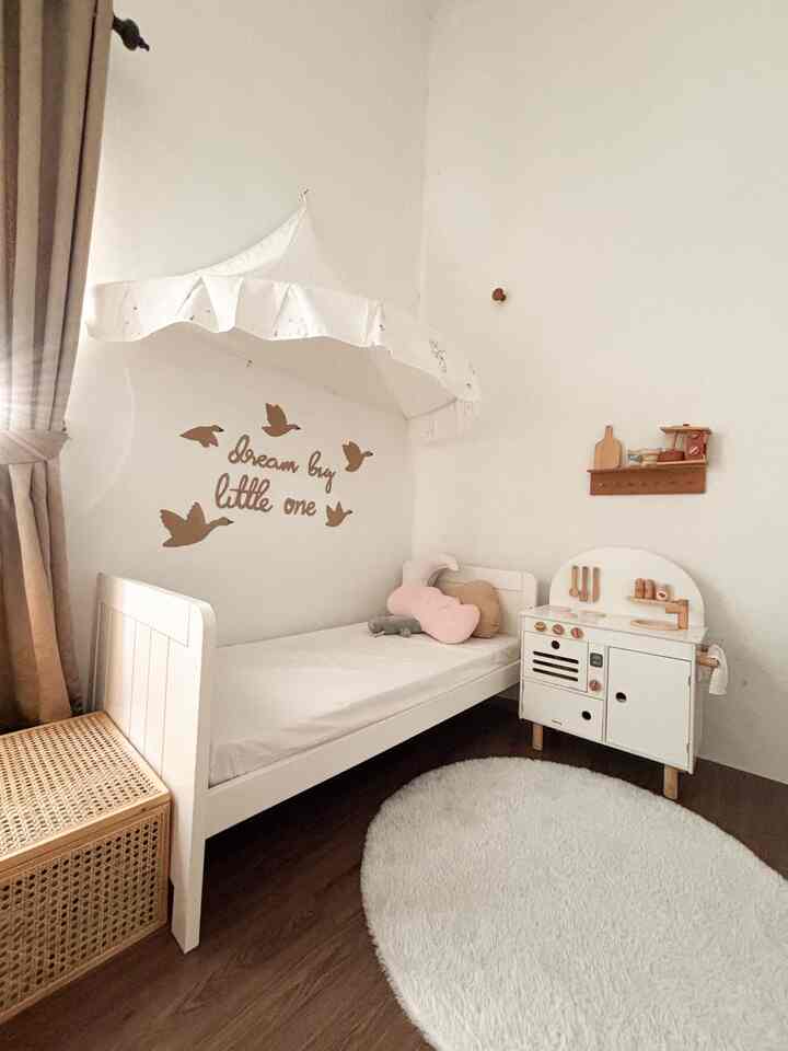 White and brown toned kids' bedroom featuring a child bed and toy kitchen in a cozy setting
