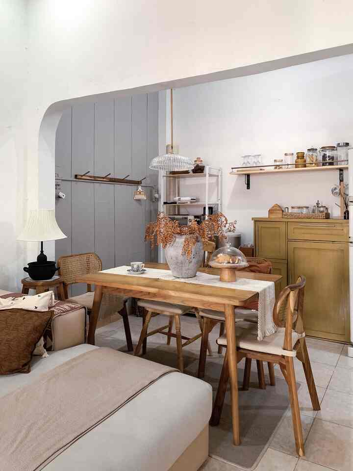 Natural wood tone dining room with white walls, featuring cozy and rustic atmosphere