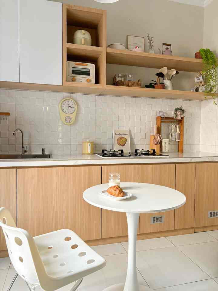 Natural wood tones and white colors blend in a kitchen featuring simple Japandi style dining table and chair
