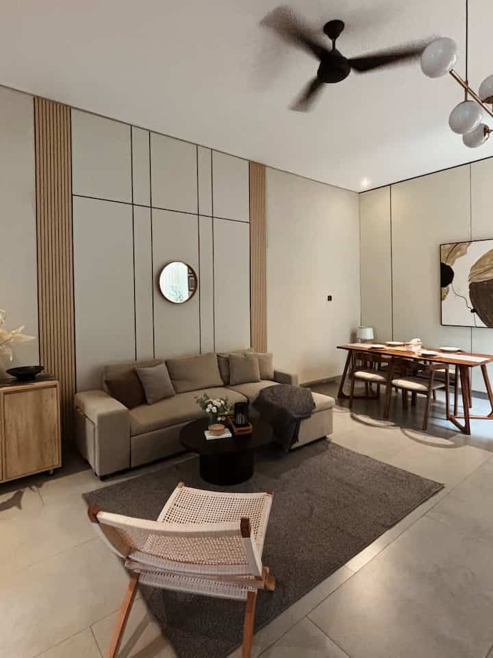 Natural wood tone and beige living room featuring dining table and sofa in a modern and cozy setting