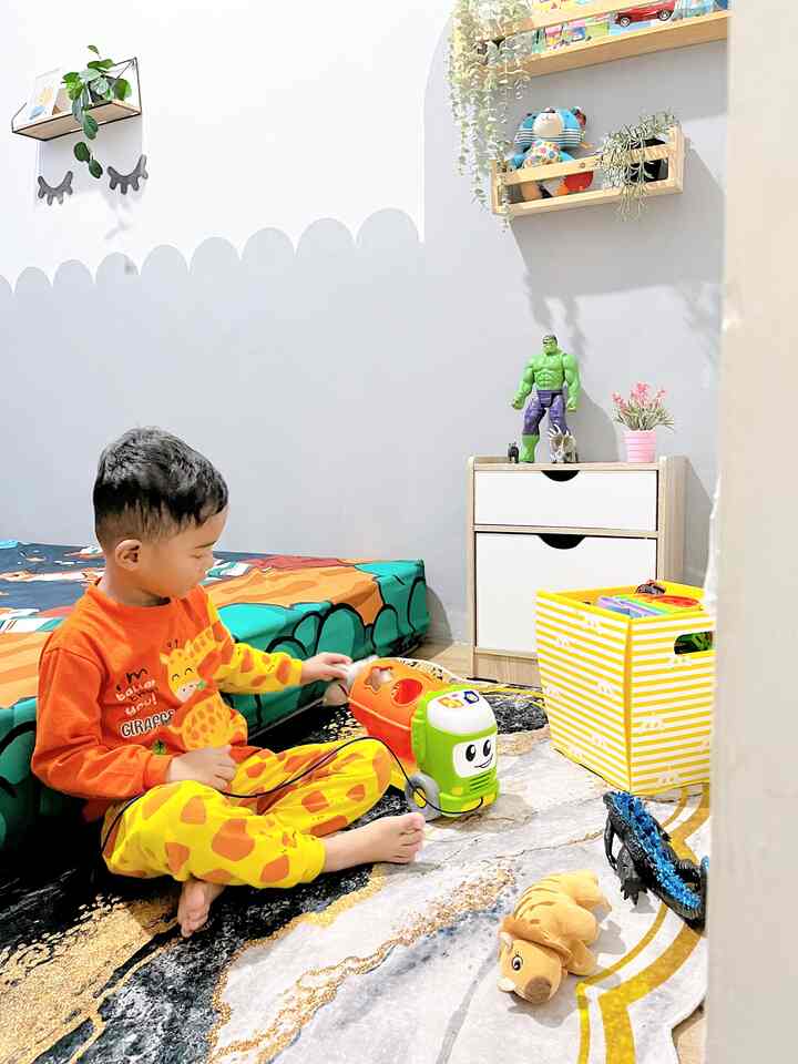 White and gray toned kids' room featuring colorful toys and a rug with a warm playful atmosphere