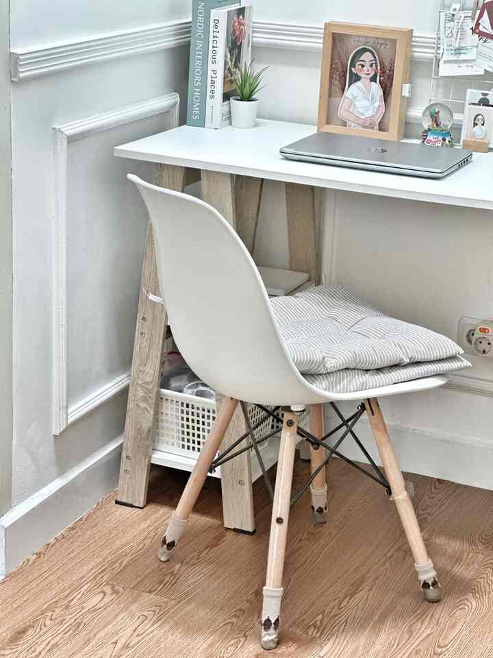 Natural color and wood tone home office space featuring a desk and chair as central elements in a cozy work area