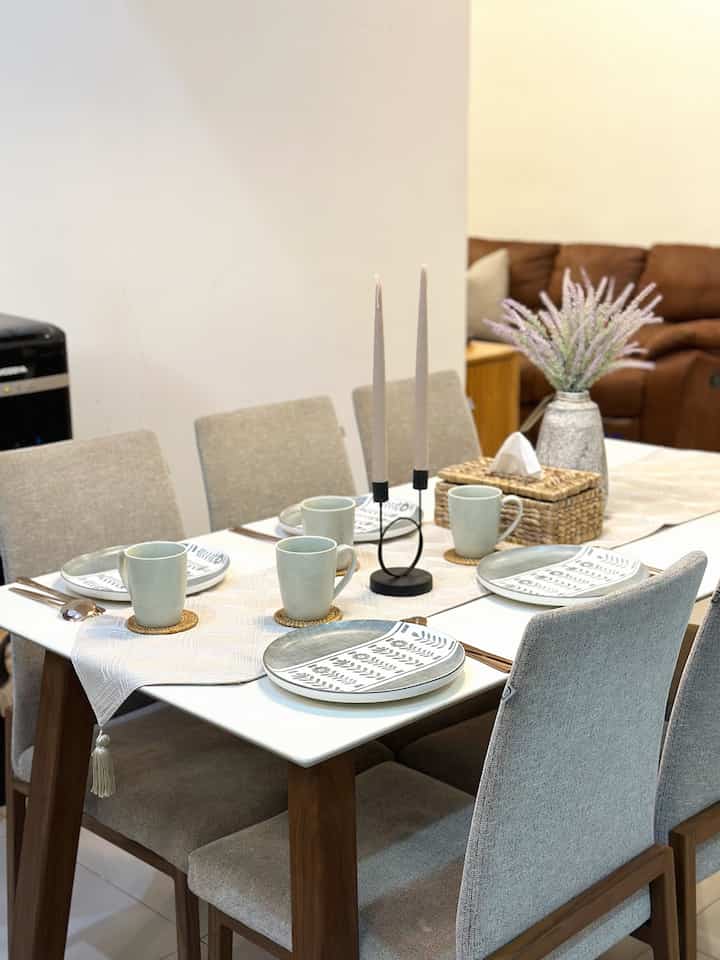 Ivory and beige toned dining room featuring a set dining table and chairs with natural, cozy atmosphere