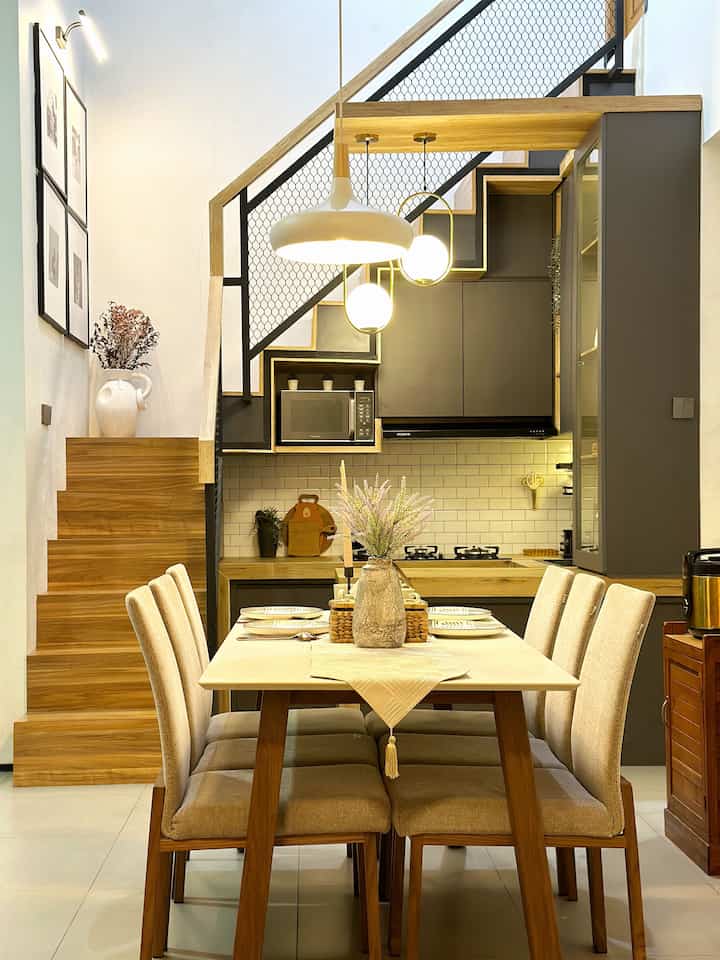 Natural wood tone dining room featuring beige dining chairs and modern rustic elements with warm atmosphere