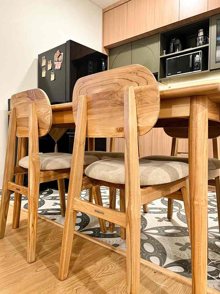 Brown wood-toned kitchen featuring a wooden dining table and chairs, creating a warm and cozy atmosphere