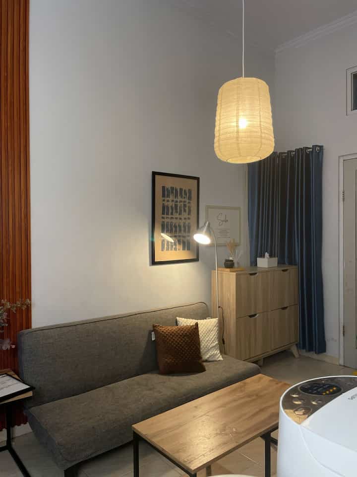 Everyone has a favorite corner in their home, and this is mine: a cozy spot in the living room where I can unwind with my favorite book. ✨ 

📖 Simple activities like reading, with soft pillows and dim lights, are always an escape after a busy day. There's something so calming about being immersed in a story, accompanied by a cup of warm tea and the warm atmosphere of home. 

🛋️ Where? Here, in the corner of the living room, surrounded by simple yet meaningful minimalist decorations. Abstract posters and the quote "Sabr" that always reminds us to be patient, make the atmosphere feel more peaceful. 

What's your favorite moment at home? 🏡

#homedecor #livingroomvibes #momendifavorit #minimalisdesign #cozycorner #interiorrumah #rumahindah
#SantaiDiRumah #SofabedMinimalis #RuanganFavorit