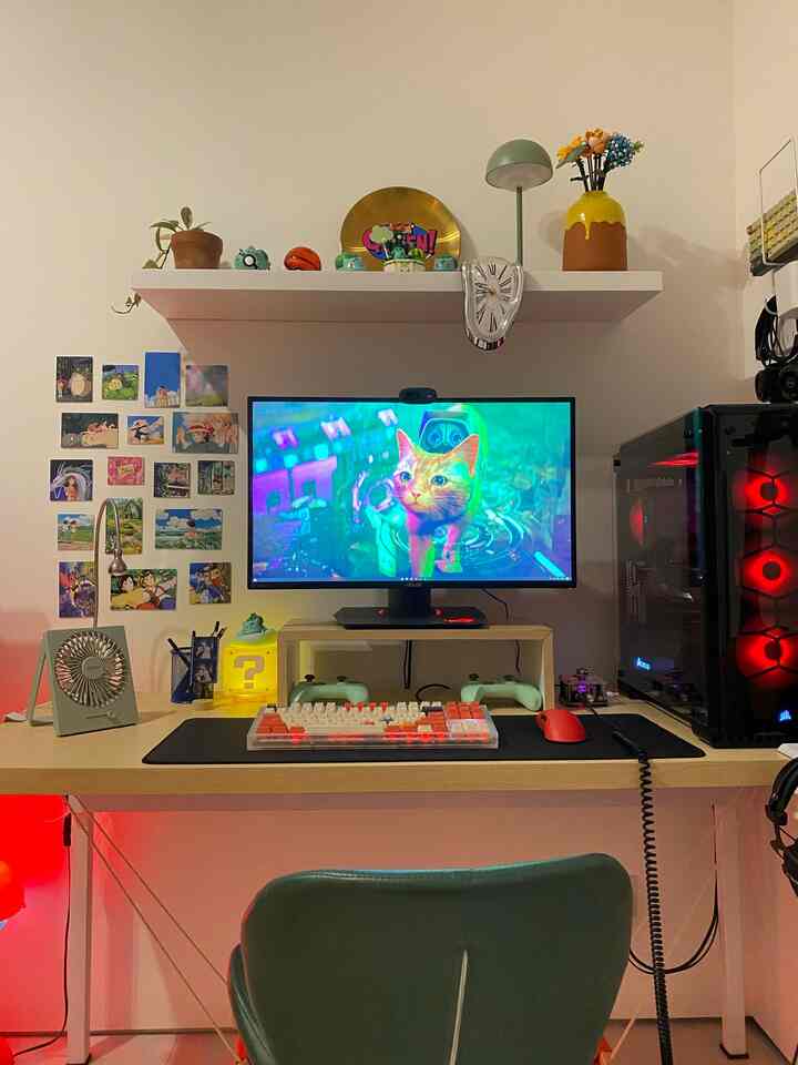 Natural tone gaming room featuring a central desk with gaming monitor, keyboard, PC case, surrounded by wall decor and lighting accessories