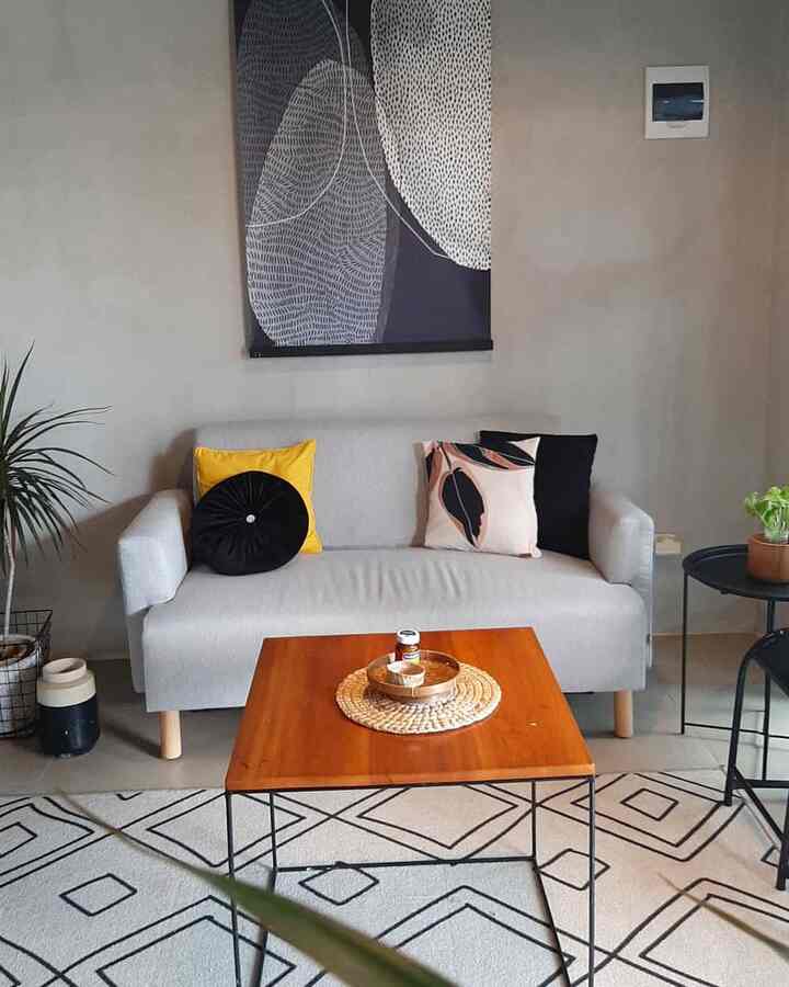 Natural color toned living room featuring beige sofa, wooden coffee table, and plants in a clean and modern space