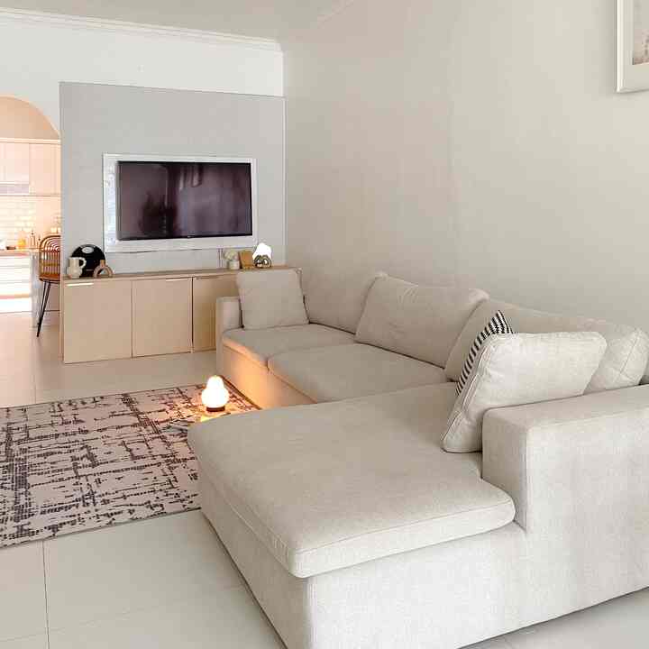 Beige and gray toned living room featuring modular sofa, minimalist carpet, and a rechargeable pear-shaped floor lamp creating a cozy atmosphere