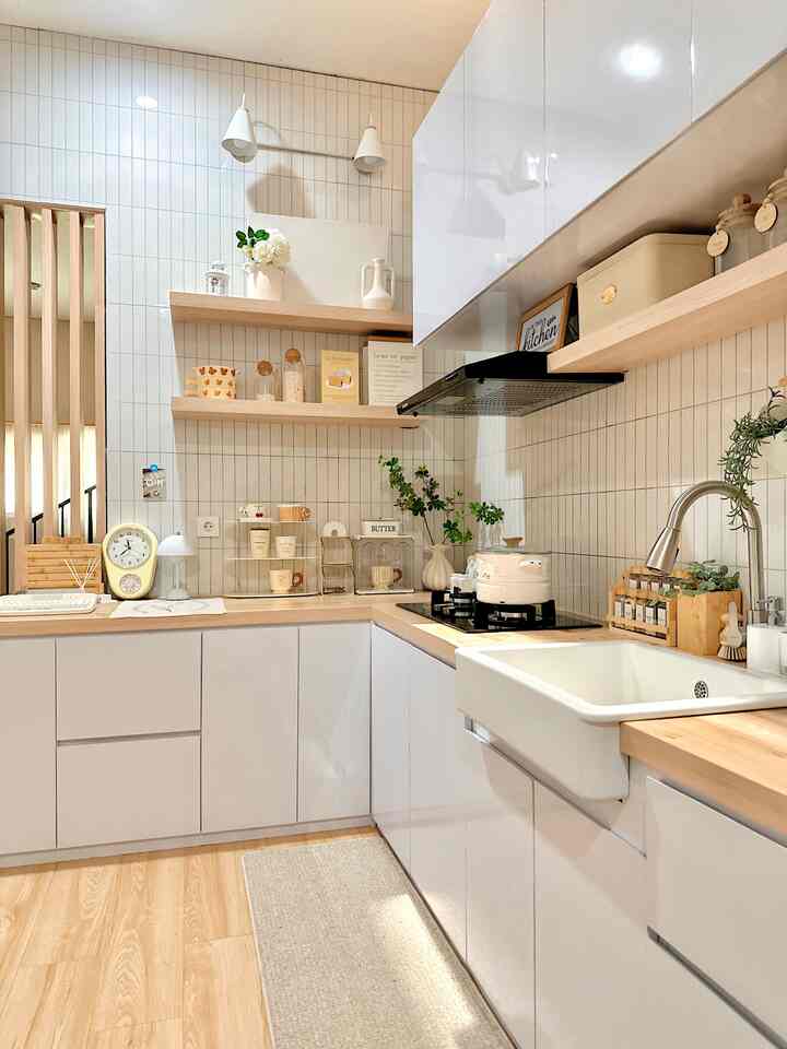 White and wood tone kitchen featuring clean sink and cooking space with warm and natural interior design