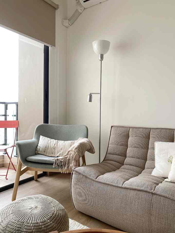 Gray and natural tone living room featuring sofa and armchair with a modern and cozy atmosphere