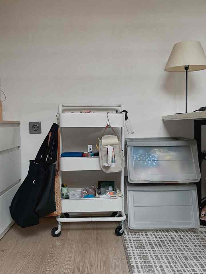 White-toned storage cart and gray storage bins in a small tidy corner of a room