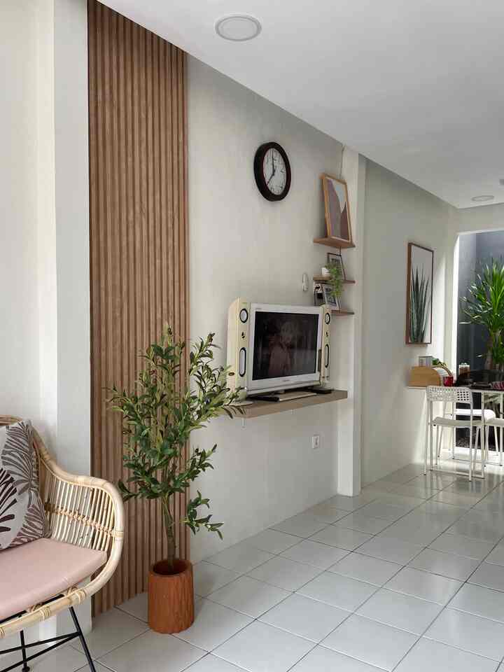 White and natural color small living room featuring open layout with rattan sofa and dining chairs, creating a simple and comfortable space
