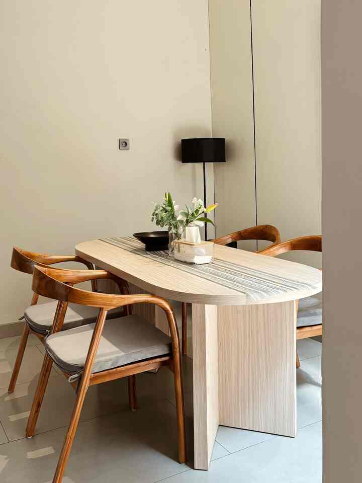 Natural dining room with bright wood tone table and chairs, warm and spacious atmosphere