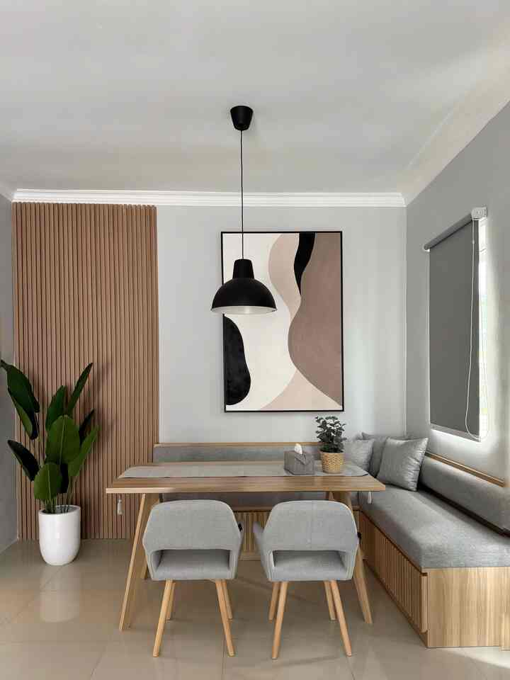 Gray and wood-tone dining room featuring custom bench and pendant light with a natural modern vibe