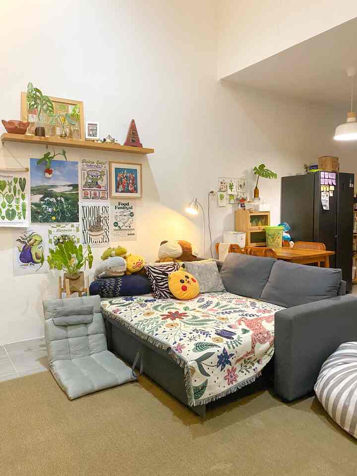 Natural-toned living room and dining area featuring gray sofa and wooden furniture, cozy family-friendly space
