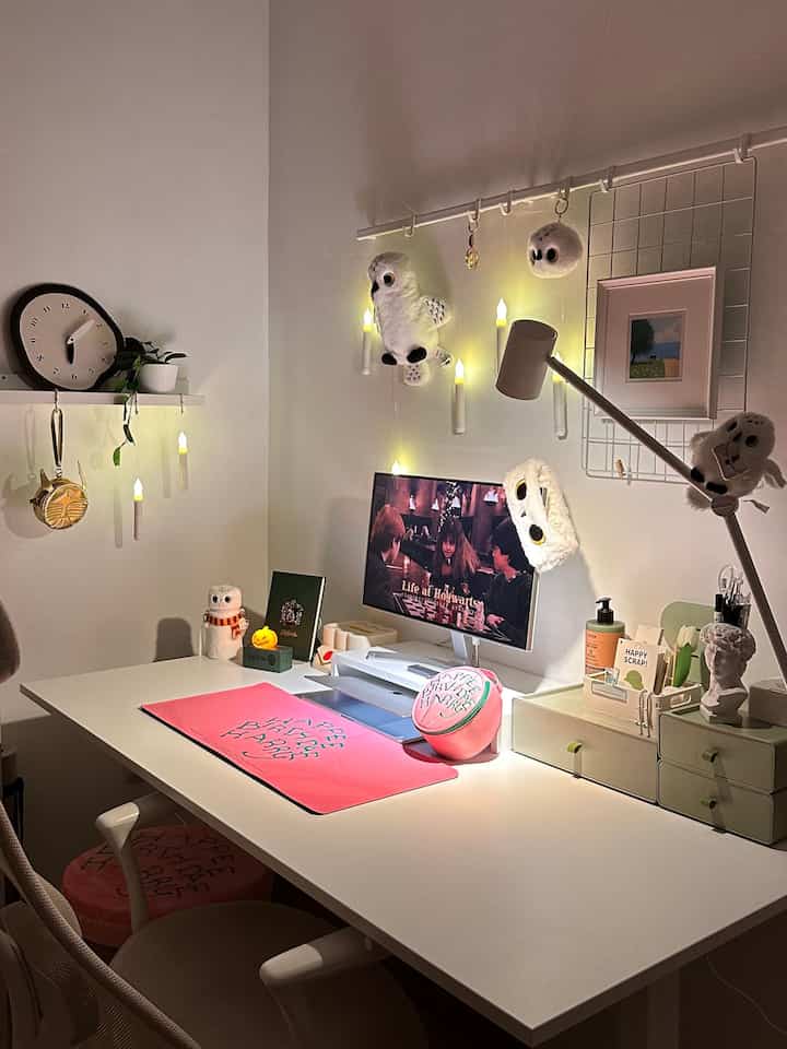 Bright and clean white-toned home office featuring a desk with cute owl decorations and pink accessories