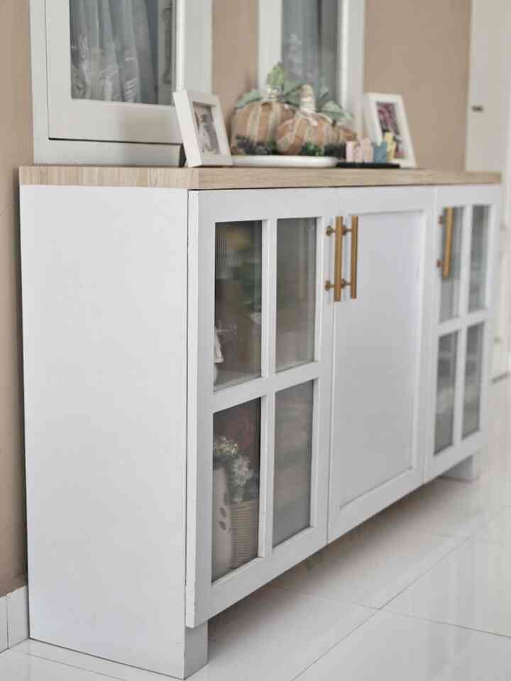 Clean living room space with a natural tone storage cabinet against beige walls
