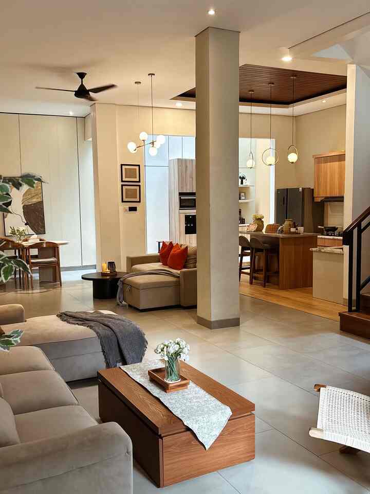 Brown and beige toned living room and kitchen featuring wooden furniture and wall panels in a natural modern interior
