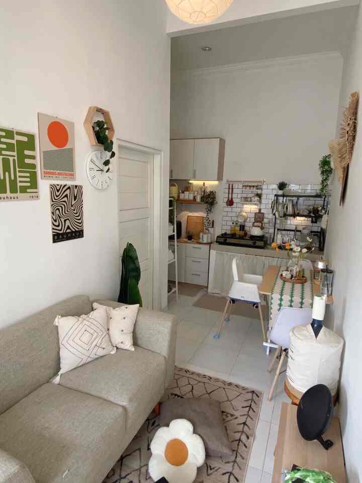 Bright beige and white toned compact 1LDK living room and kitchen featuring natural modern style with plants and minimal decor