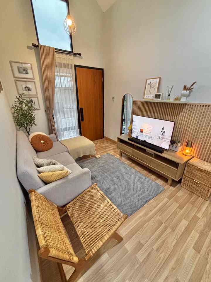 Light gray and natural brown toned living room featuring gray sofa and carpet with neat, cozy ambiance