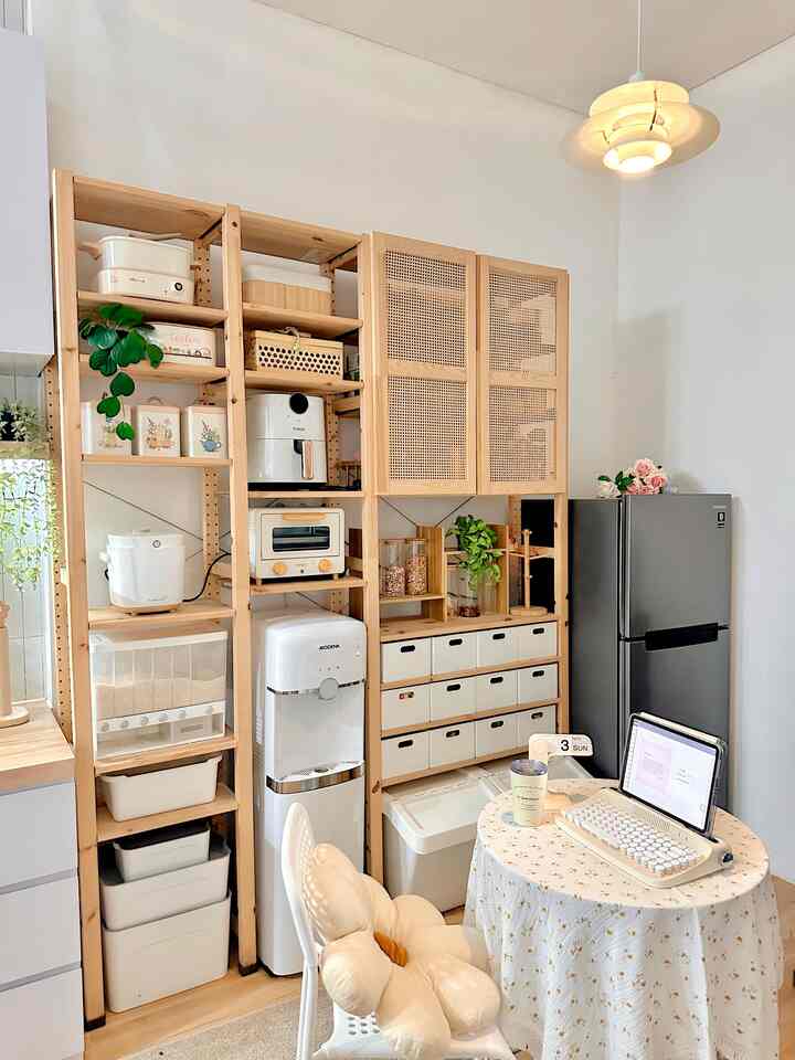 White-walled and wood-toned pantry-dining room featuring a small round table and pendant lighting creating a cozy atmosphere