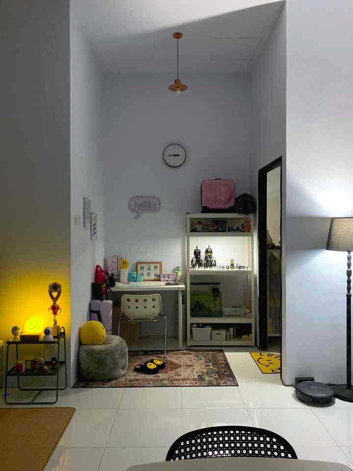 White and gray toned home office space featuring desk and shelves in a simple, compact workspace