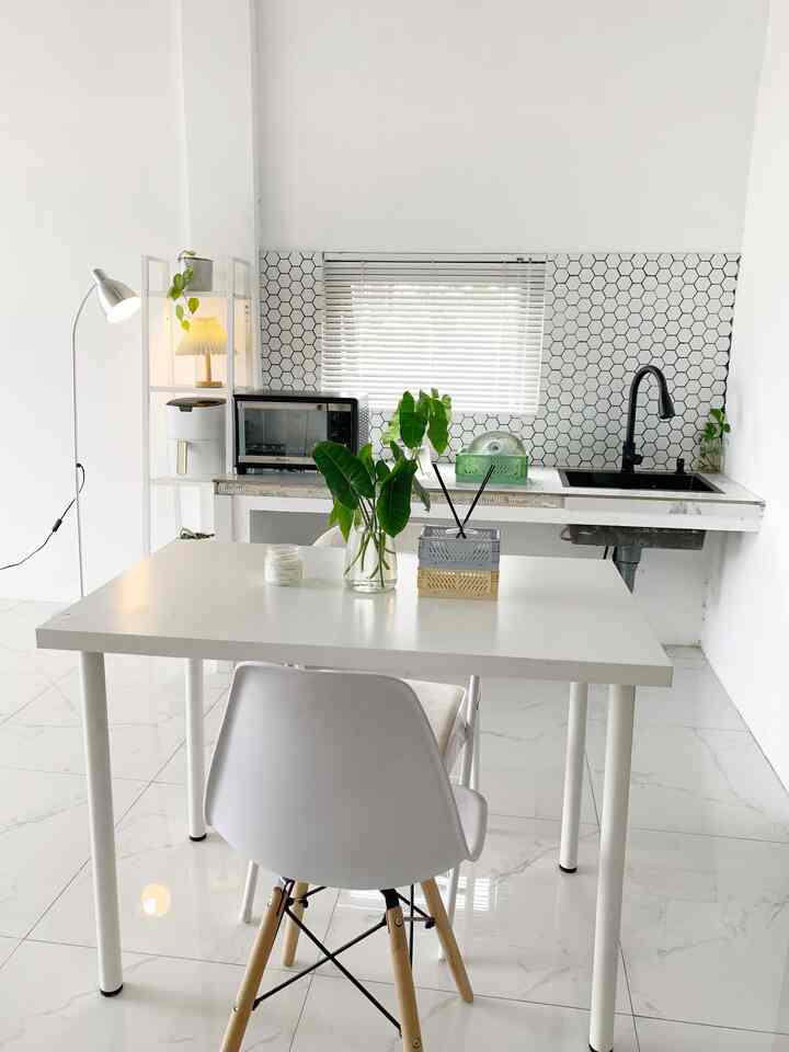 Bright minimalist kitchen and dining space in white and natural tones, clean and airy atmosphere