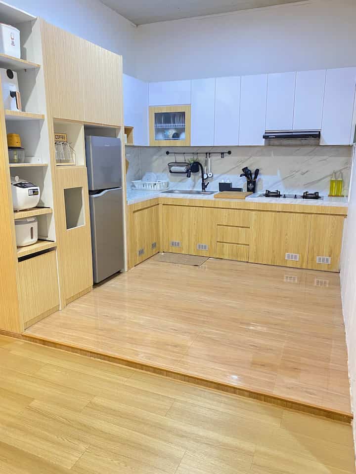 Japandi style kitchen featuring wood tones and white cabinetry, simple and clean multifunctional space