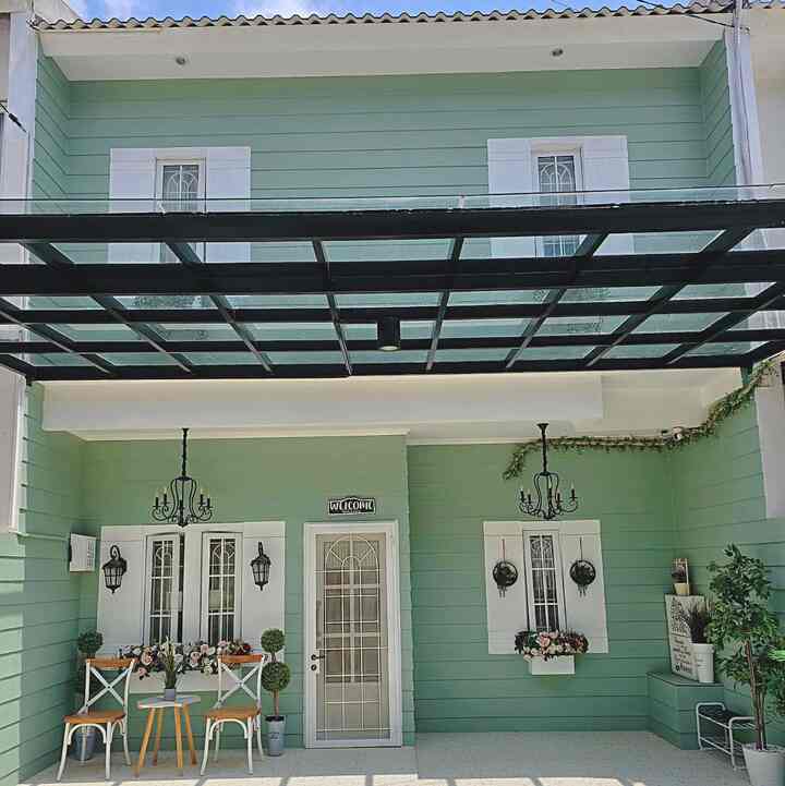 Soft green walls with white trim balcony area featuring outdoor table and chairs creating a cozy atmosphere
