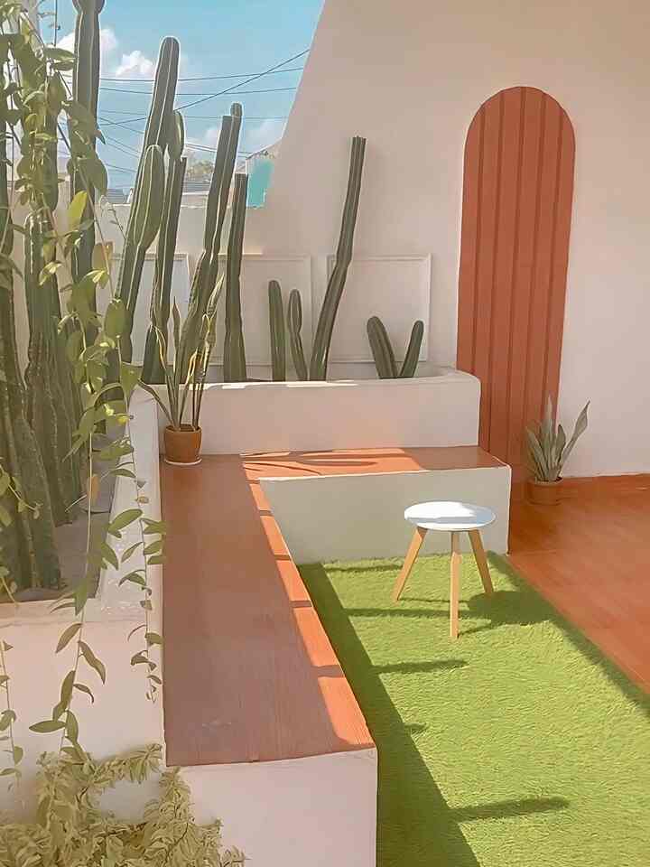 Natural color and wood tone balcony featuring a bench and plants in a relaxed seating area