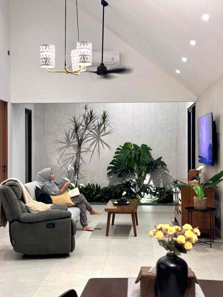 Gray and wood tone modern living room featuring sofa and plants in a comfortable space