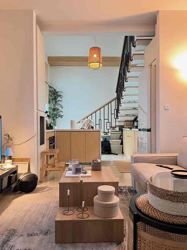 Beige and wood-tone living room featuring sofa, coffee table, and a pendant light, creating a cozy and natural atmosphere