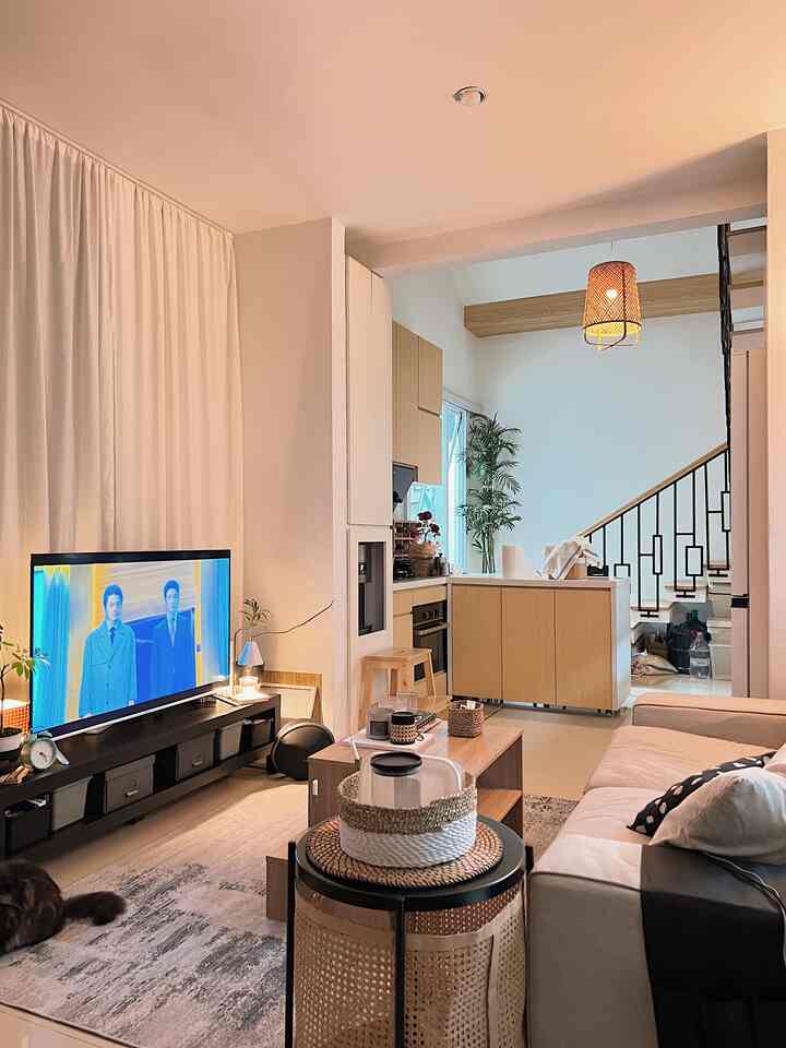 Natural color and wood tone cozy living room and kitchen space featuring sofa and coffee table with warm, inviting atmosphere