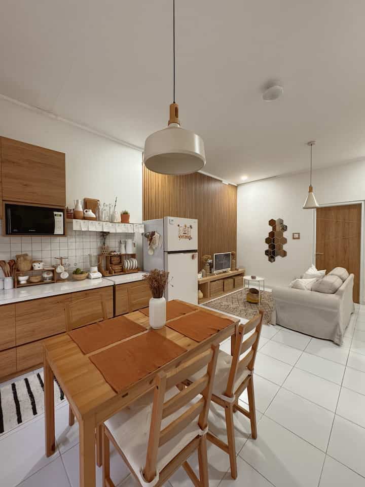 White and wood tone dining and living room featuring simple modern style with cozy atmosphere