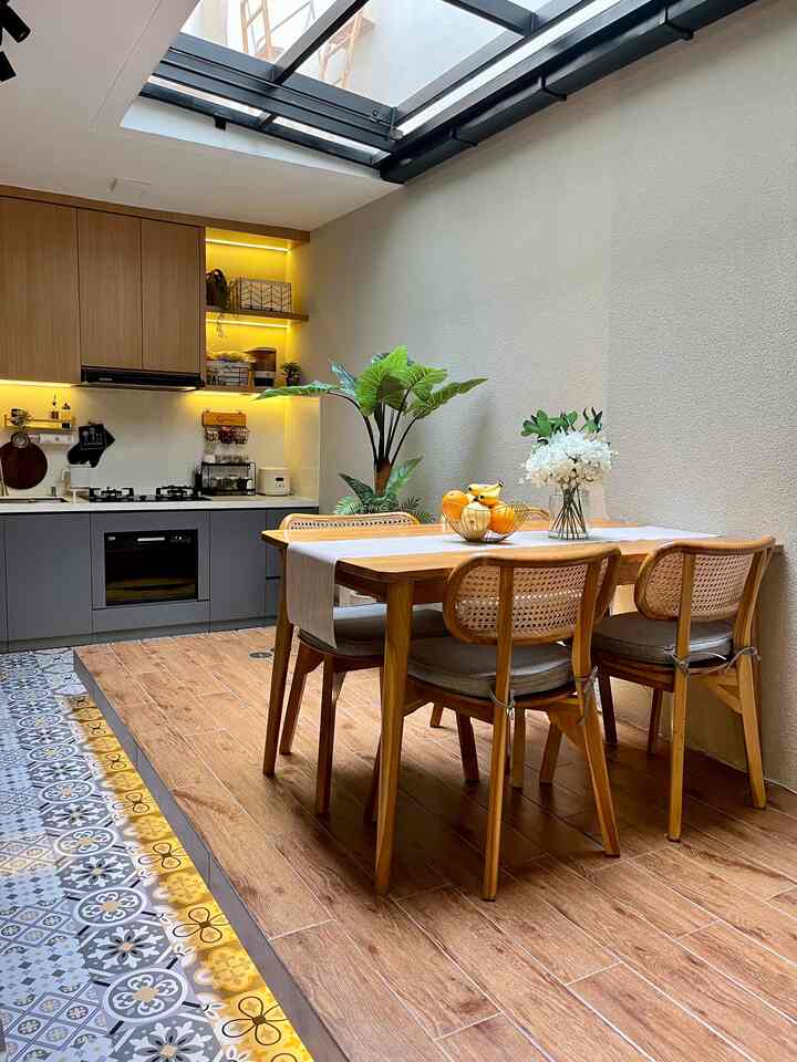 Natural modern kitchen dining space with light brown wood-tone flooring and a dining table