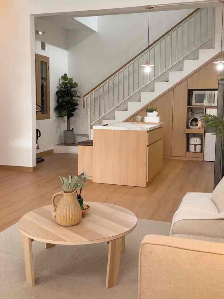 A simple, natural living room and kitchen featuring wood tones and white walls in harmony