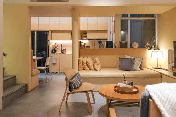 Warm beige and wood tone open plan kitchen and living room with cozy natural furnishings