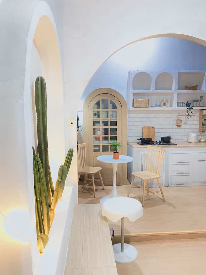 Natural tones and white-walled kitchen and dining room with a clean, cozy atmosphere