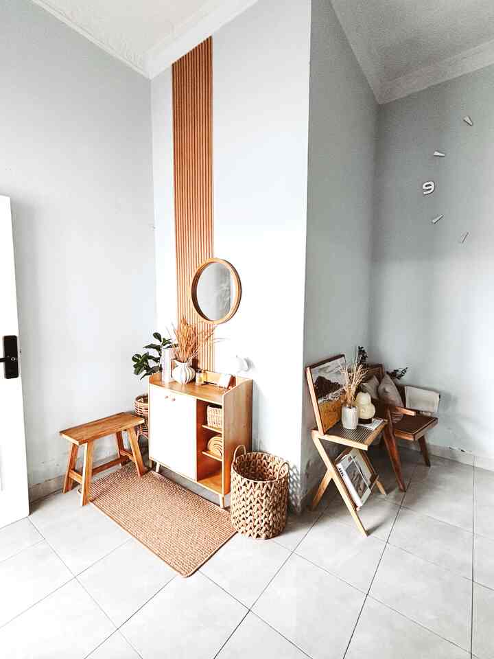 Bright white walls and wood-tone furniture in a natural and simple entrance interior