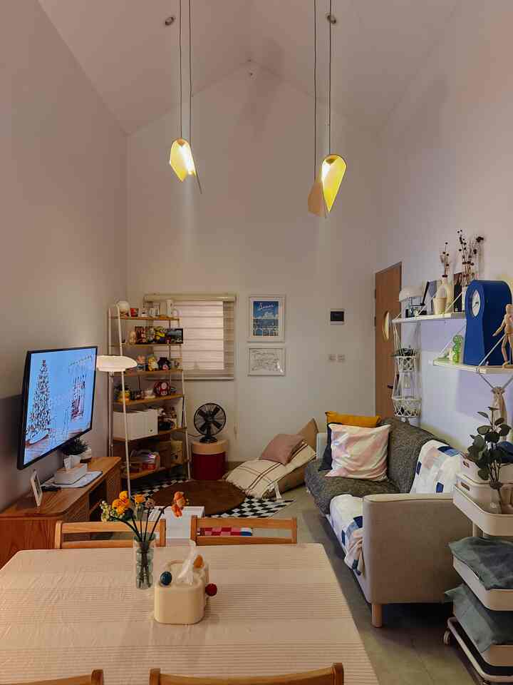 White-walled living room with brown furniture in a two-person household setting featuring a sofa and table runner for a cozy atmosphere