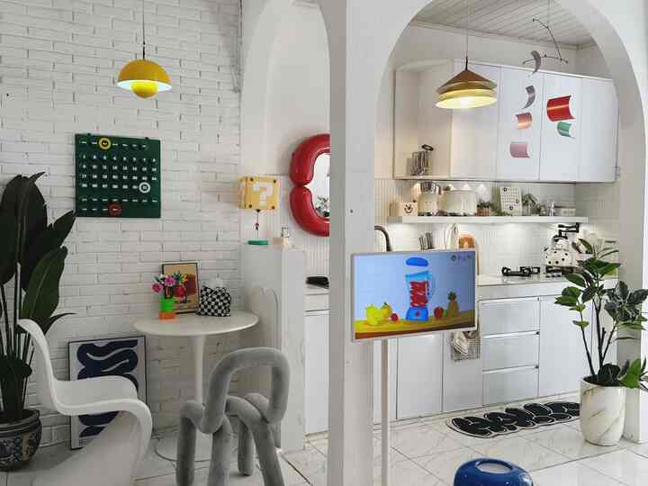 Bright white and yellow-accented kitchen and dining space with simple, modern interior design