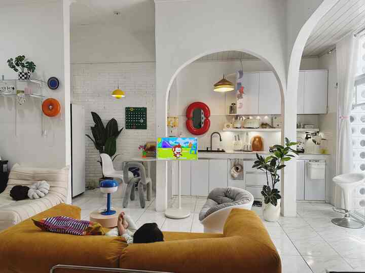 White and orange toned kitchen and living space featuring archway walls and modern furniture in a bright, open interior
