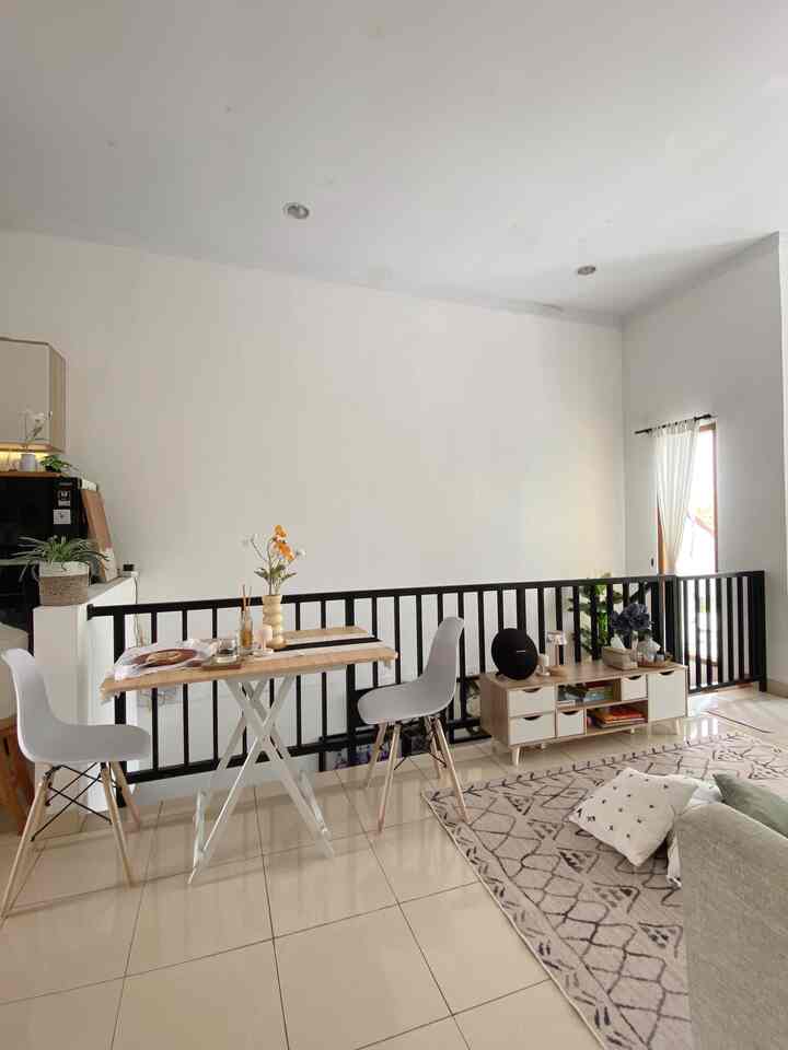 White and natural tone dining room featuring a folding dining table and patterned carpet with a clean atmosphere