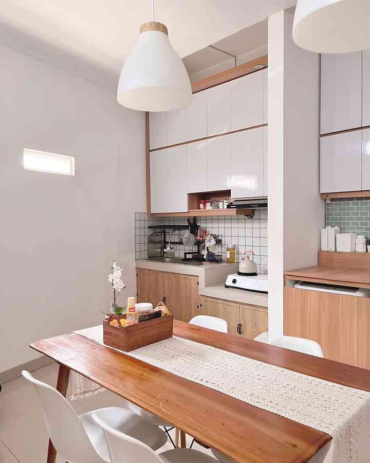 White and wood tone kitchen and dining room for a 4-person household, featuring a table runner on a simple wooden table