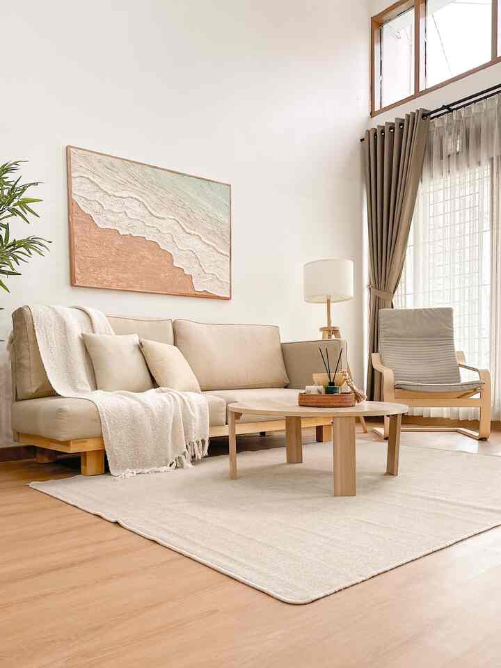 Beige and natural-toned living room featuring wooden coffee table and sofa with a cozy natural ambiance