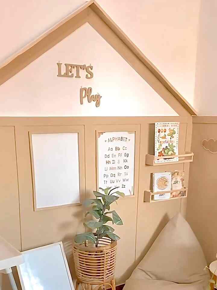 Warm brown-toned kids' room corner featuring a bean bag, alphabet wall art, and a rattan plant pot creating a cozy atmosphere