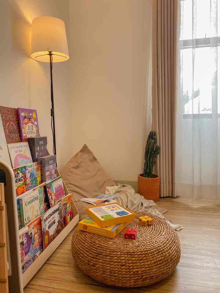 Beige and wood tone kids' room featuring bean bag and storage rack, creating a cozy atmosphere